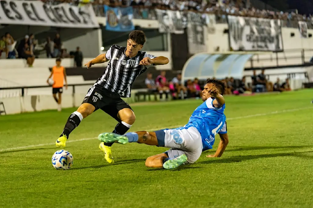 intense soccer match tackle under stadium lights