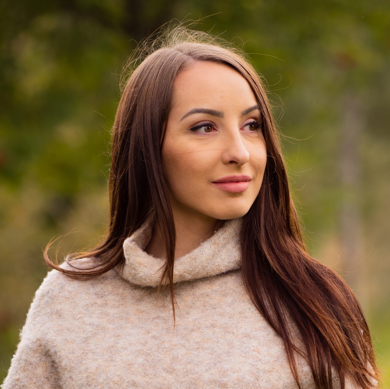 Image of a woman standing on the grass outside 